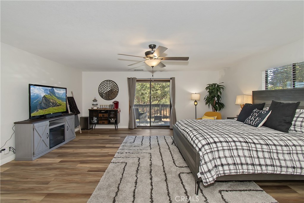 198 Zermatt Drive Crestline, CA 92325 - Photo 32 of 54 a spacious bedroom with a bed and a flat screen tv