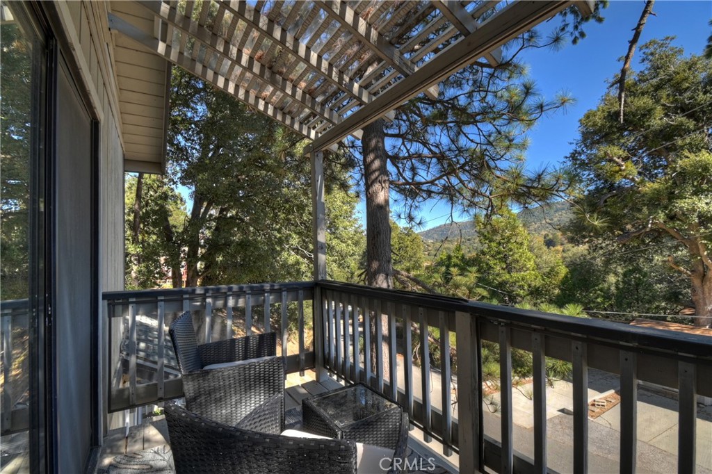 198 Zermatt Drive Crestline, CA 92325 - Photo 38 of 54 a balcony with wooden floor and outdoor seating