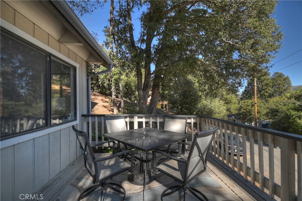 198 Zermatt Drive Crestline, CA 92325 - Photo 41 of 54 a view of balcony with table and chairs and wooden fence