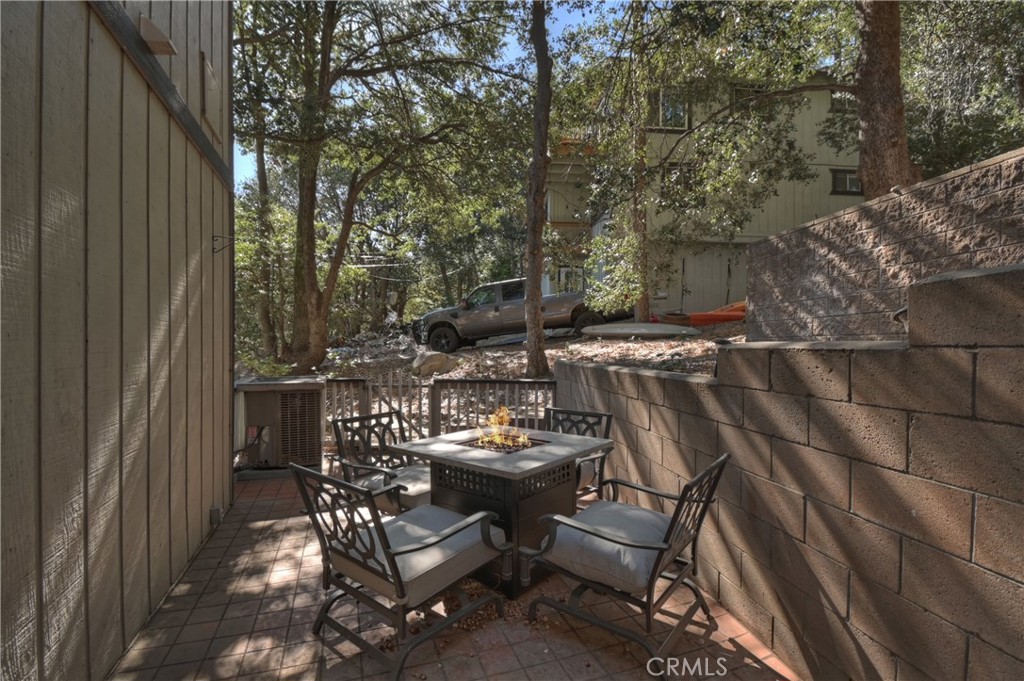 198 Zermatt Drive Crestline, CA 92325 - Photo 44 of 54 a view of a patio with table and chairs with wooden floor and fence