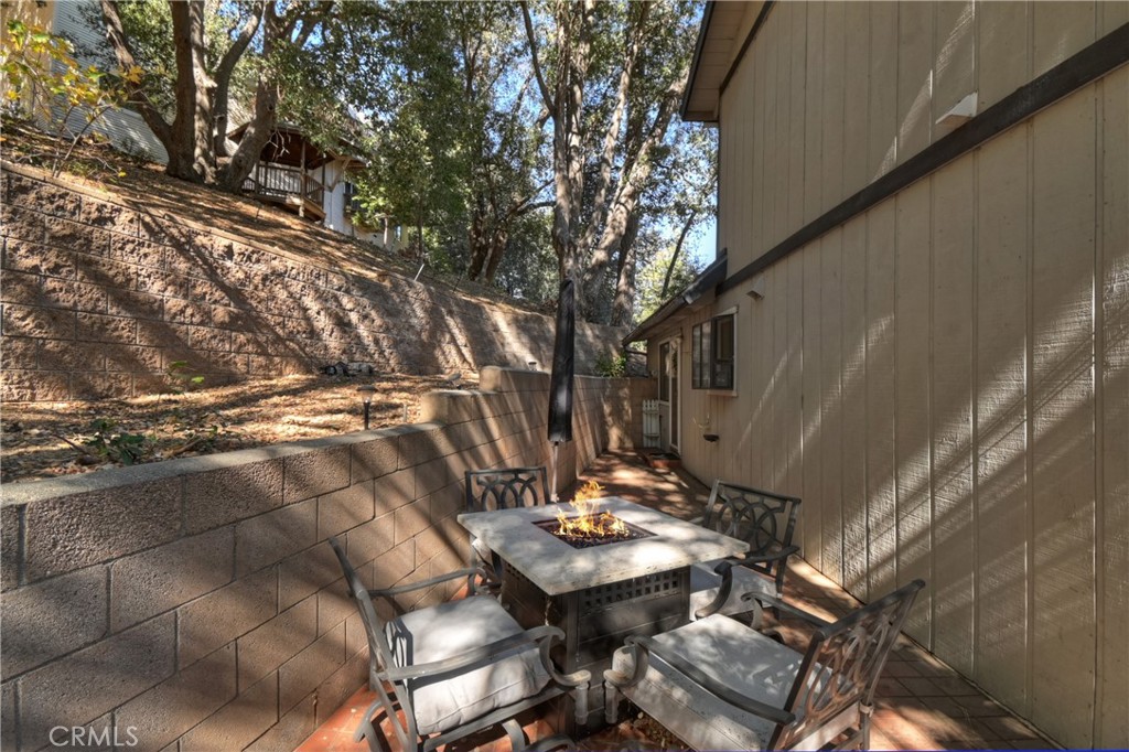 198 Zermatt Drive Crestline, CA 92325 - Photo 45 of 54 a view of patio with table and chairs and potted plants