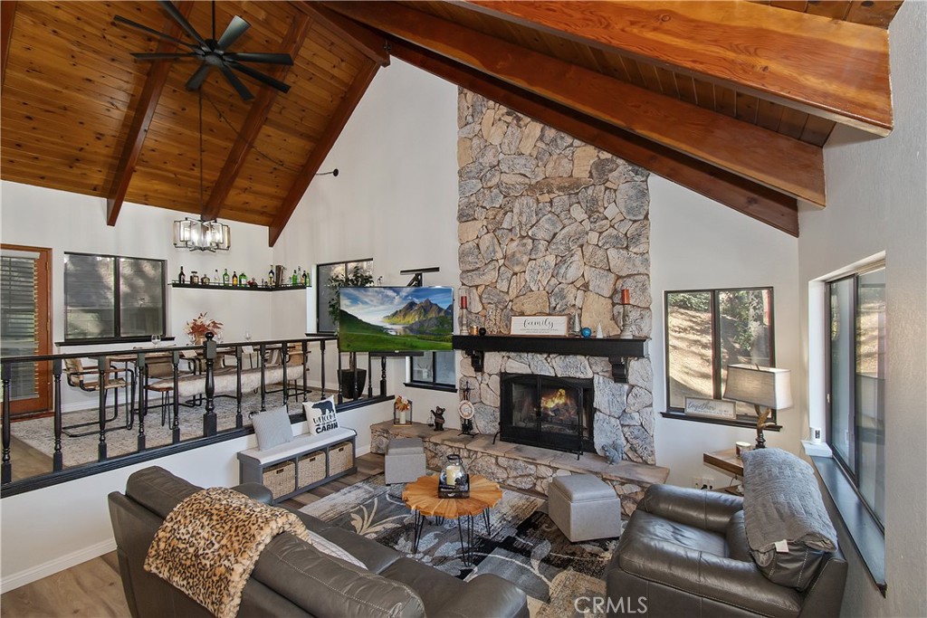 198 Zermatt Drive Crestline, CA 92325 - Photo 6 of 54 a living room with furniture a fireplace and a table