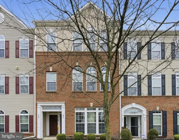 a front view of residential houses with yard