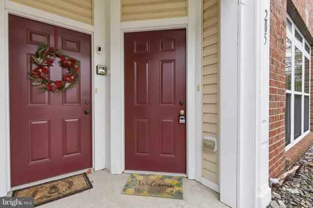 a view of front door with a red door and front door