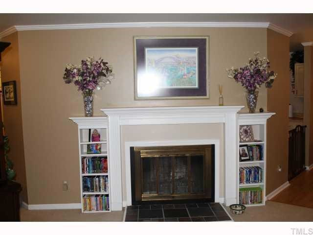 1400 Seaton Road Durham, NC 27713 - Photo 3 of 12 a living room with a bookshelf and a fireplace