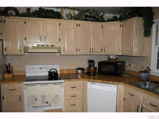 1400 Seaton Road Durham, NC 27713 - Photo 5 of 12 a kitchen with appliances a sink and cabinets