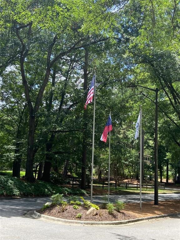 29 Chaumont Square Northwest Atlanta, GA 30327 - Photo 16 of 16 a front view of a house with lots of trees and plants