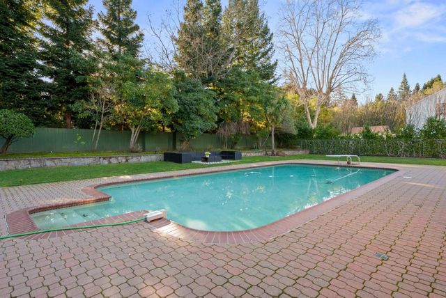 a view of a swimming pool and a yard