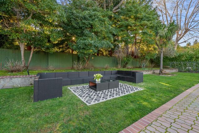a view of a chair and table in the garden
