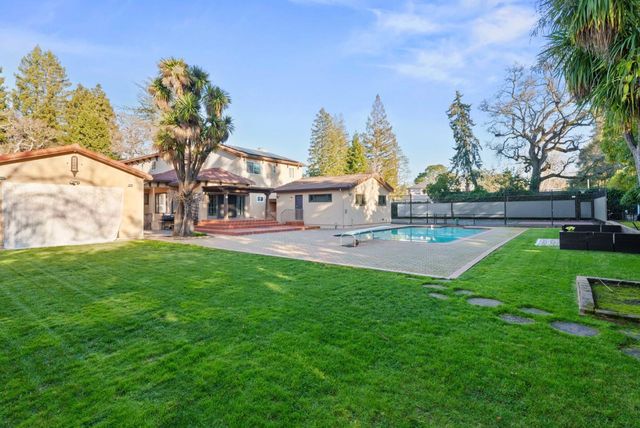 a view of outdoor space with garden and trees