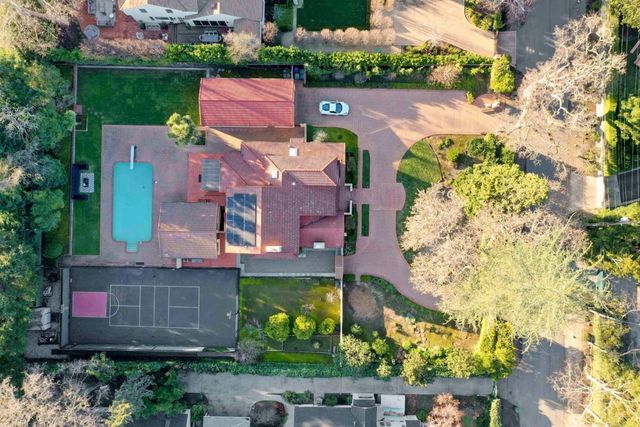 an aerial view of residential houses with outdoor space and street view