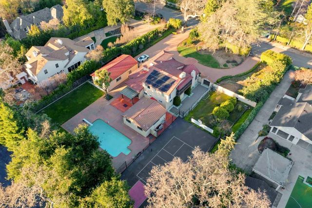 an aerial view of a house with a yard