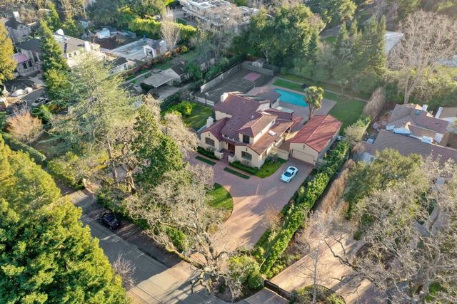 an aerial view of a house with a yard