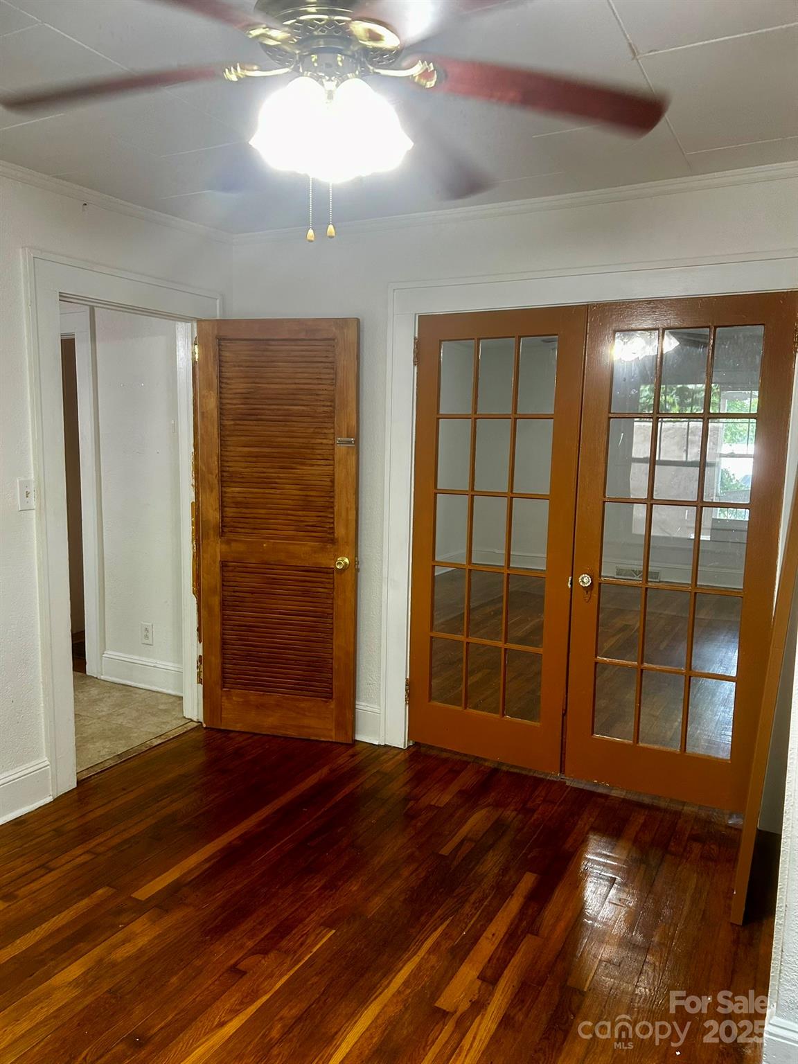 404 Huffman Street Morganton, NC 28655 - Photo 12 of 29 an empty room with wooden floor and windows