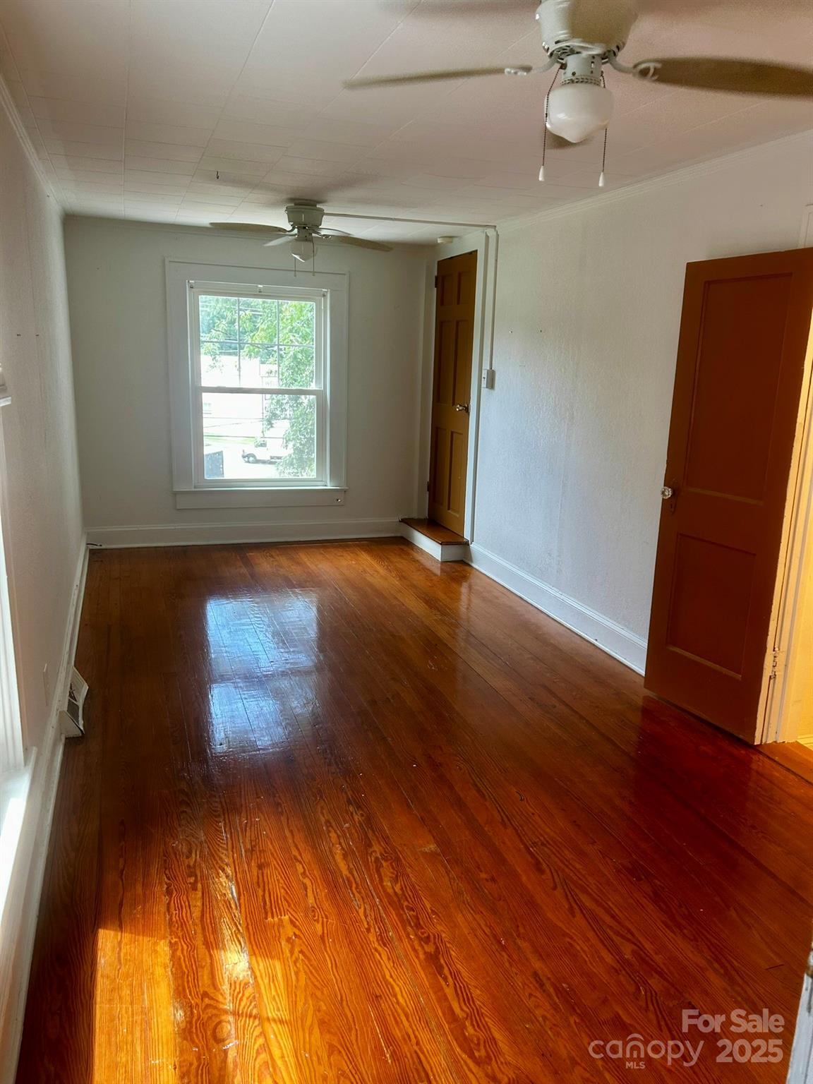 404 Huffman Street Morganton, NC 28655 - Photo 14 of 29 an empty room with wooden floor and windows
