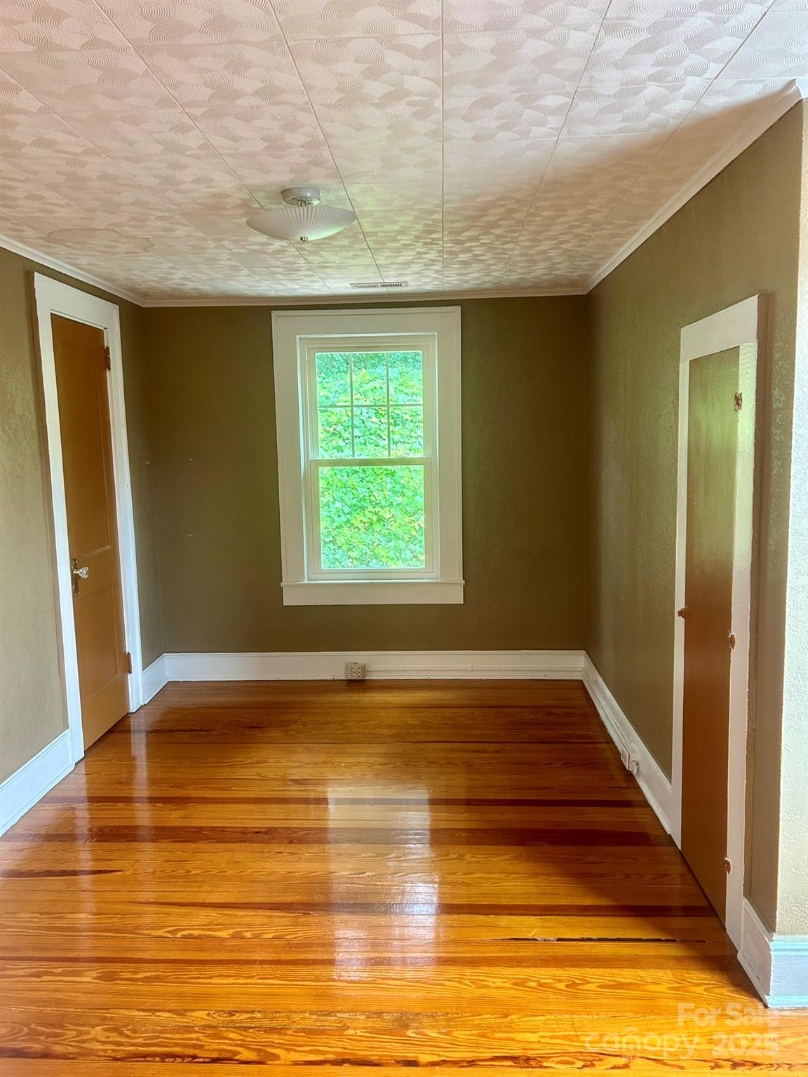 404 Huffman Street Morganton, NC 28655 - Photo 17 of 29 a view of an empty room with wooden floor and a window