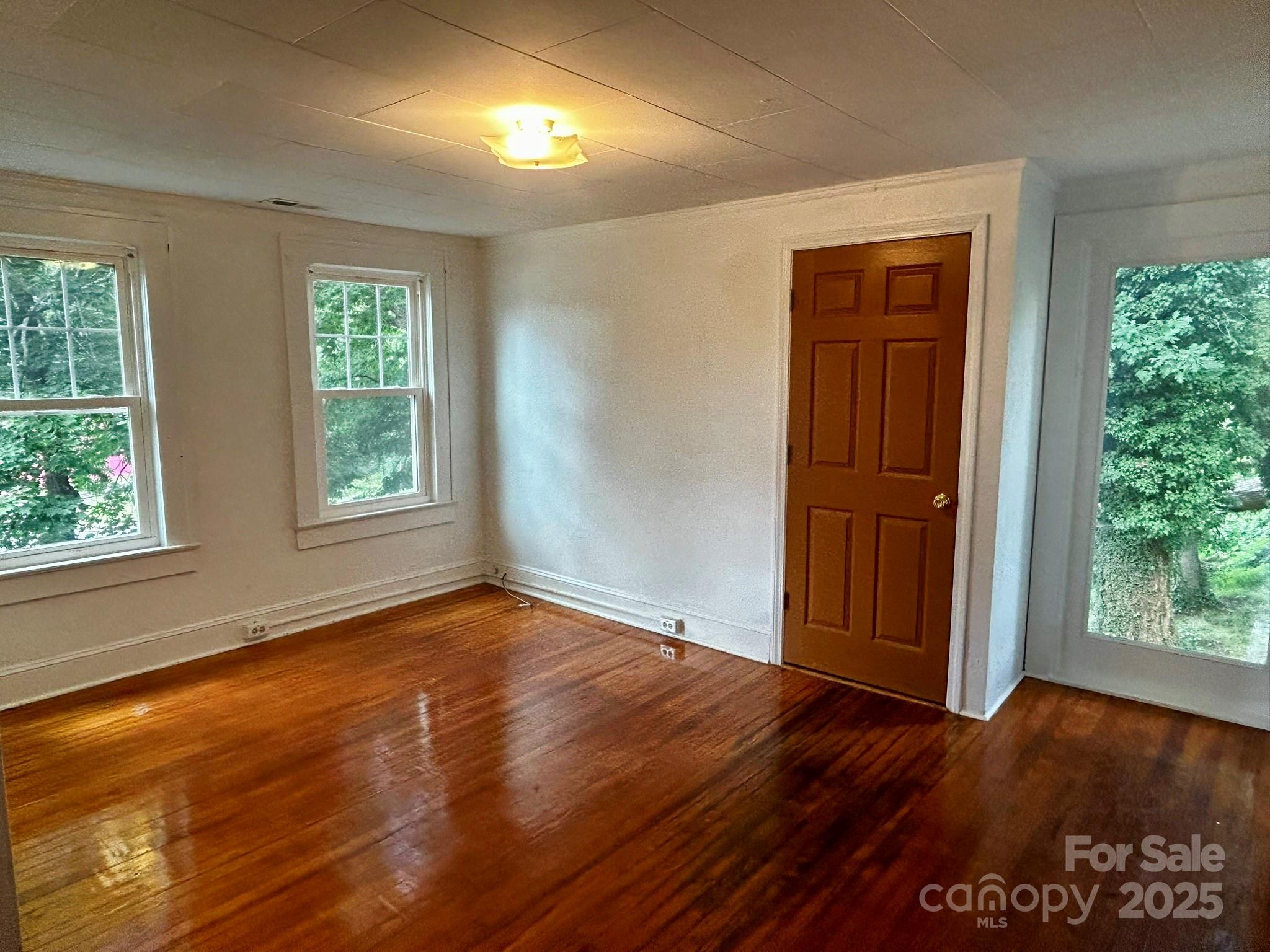 404 Huffman Street Morganton, NC 28655 - Photo 20 of 29 an empty room with wooden floor and windows