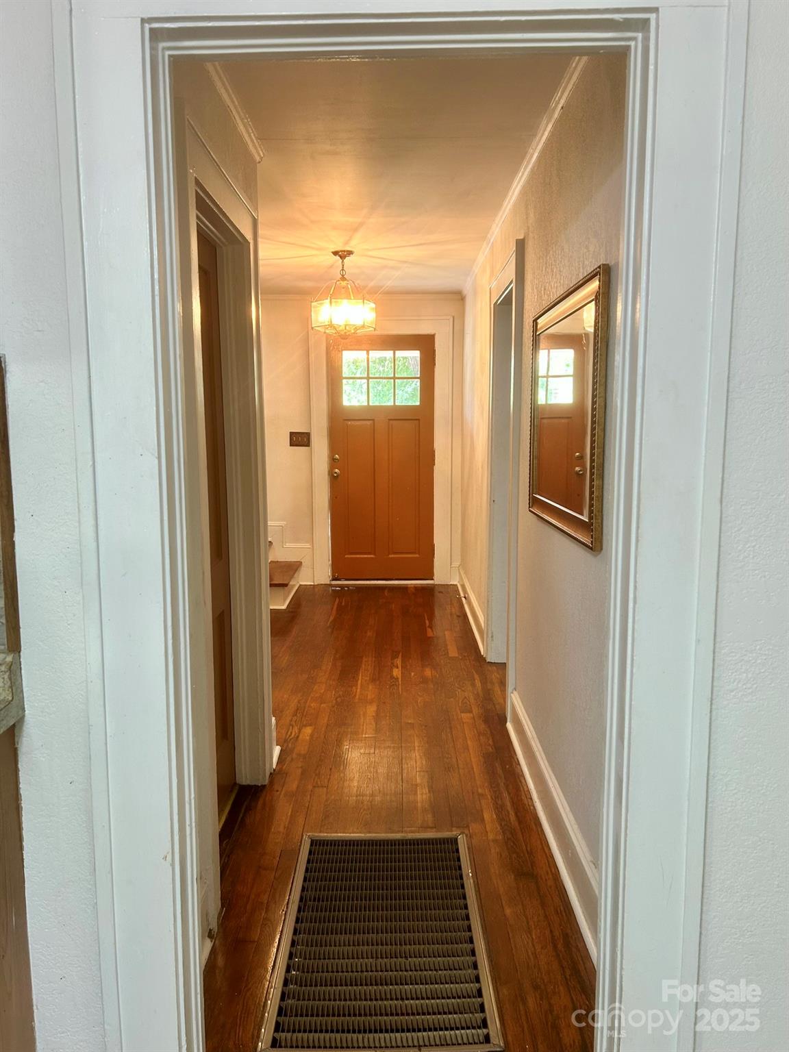 404 Huffman Street Morganton, NC 28655 - Photo 7 of 29 a view of a hallway with wooden floor and a bathroom