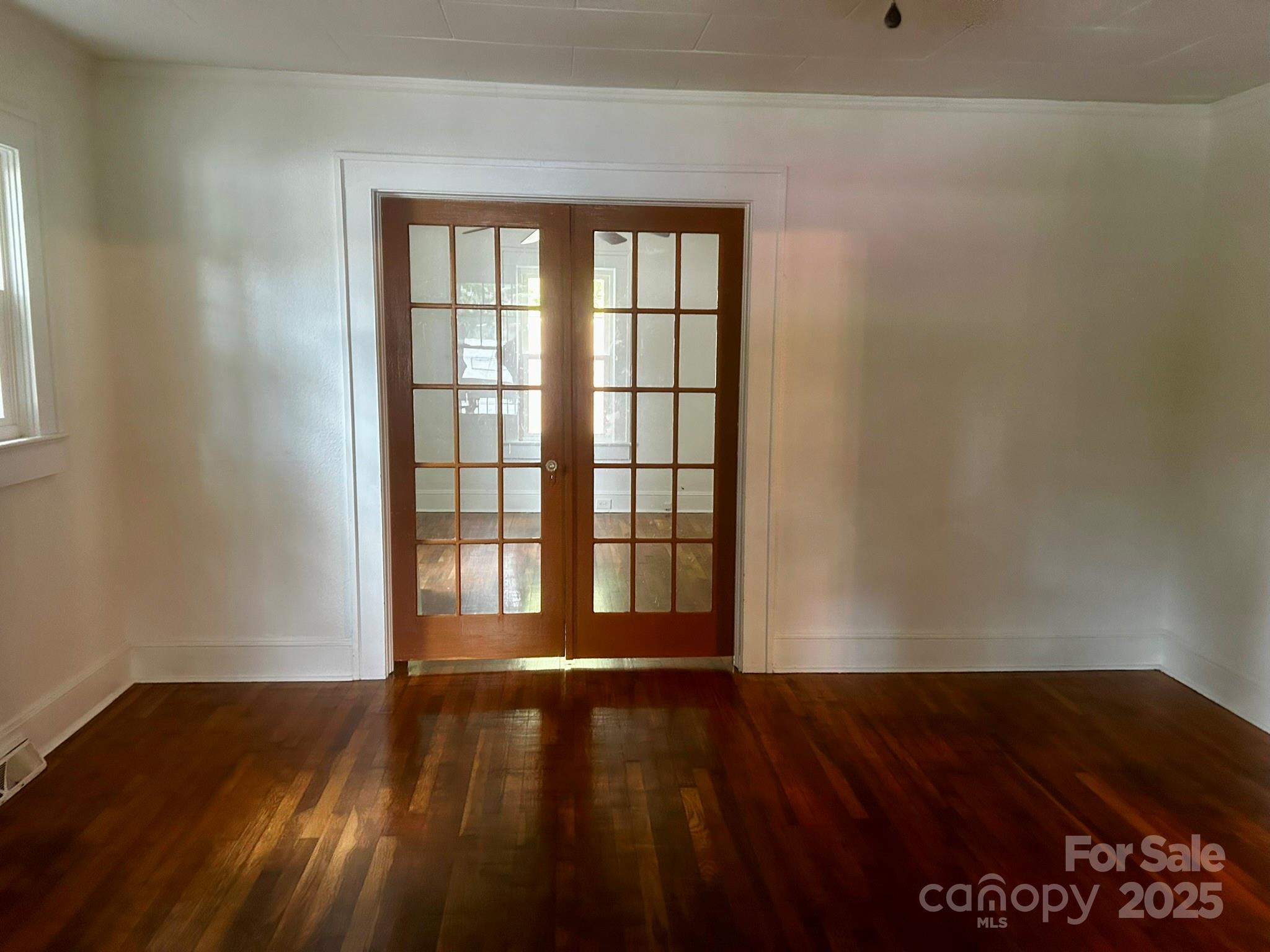 404 Huffman Street Morganton, NC 28655 - Photo 9 of 29 a view of an empty room with wooden floor and a window