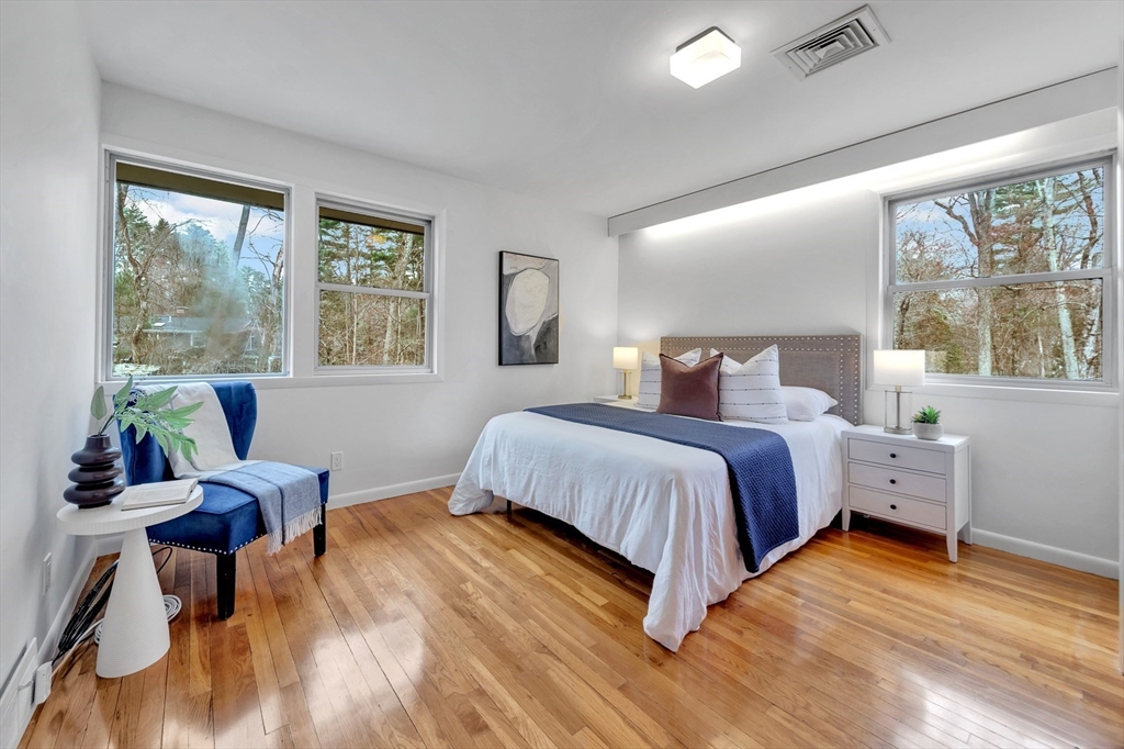 85 The Valley Road Concord, MA 01742 - Photo 23 of 38 a bedroom with a bed and large windows