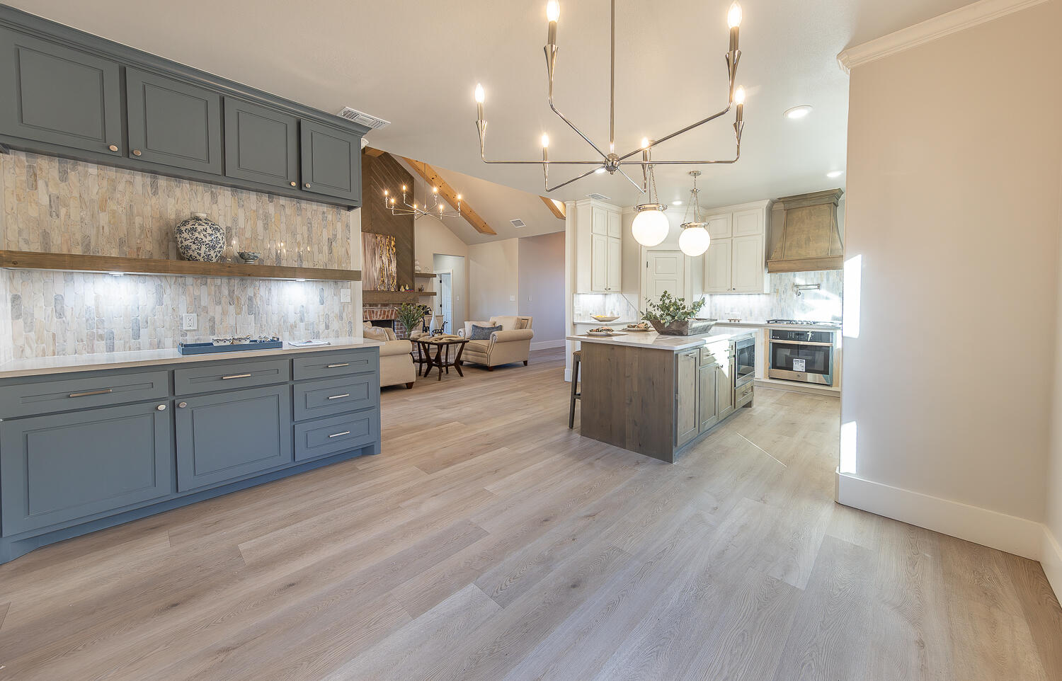 3607 143rd Street Lubbock, TX 79423 - Photo 12 of 35 a kitchen with stainless steel appliances kitchen island granite countertop a sink dishwasher a stove and a refrigerator with wooden floor