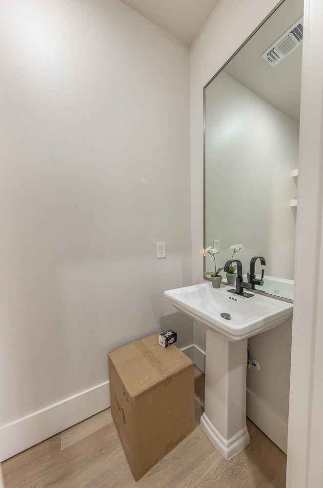 3607 143rd Street Lubbock, TX 79423 - Photo 14 of 35 a bathroom with a sink and a mirror