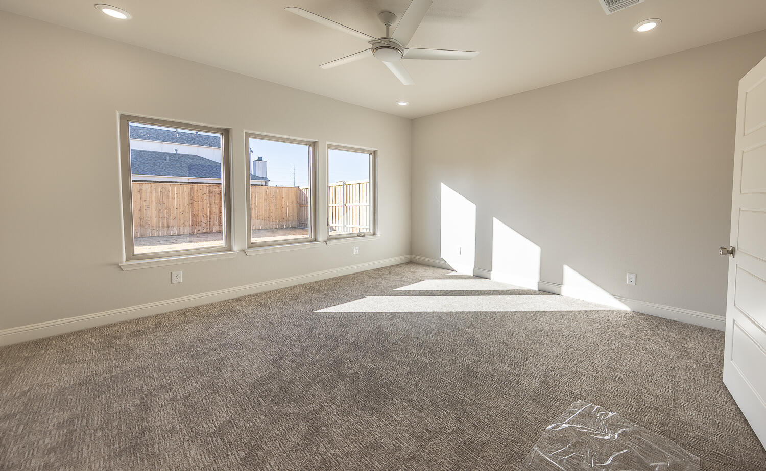 3607 143rd Street Lubbock, TX 79423 - Photo 16 of 35 an empty room with windows and ceiling fan