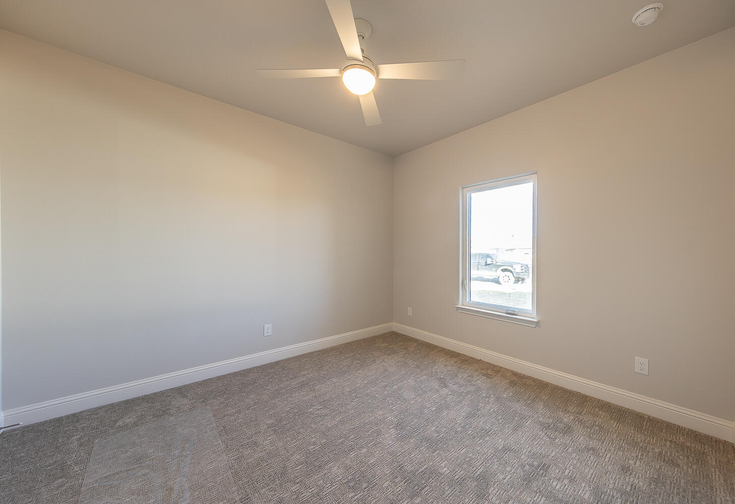 3607 143rd Street Lubbock, TX 79423 - Photo 24 of 35 an empty room with a window and a fan