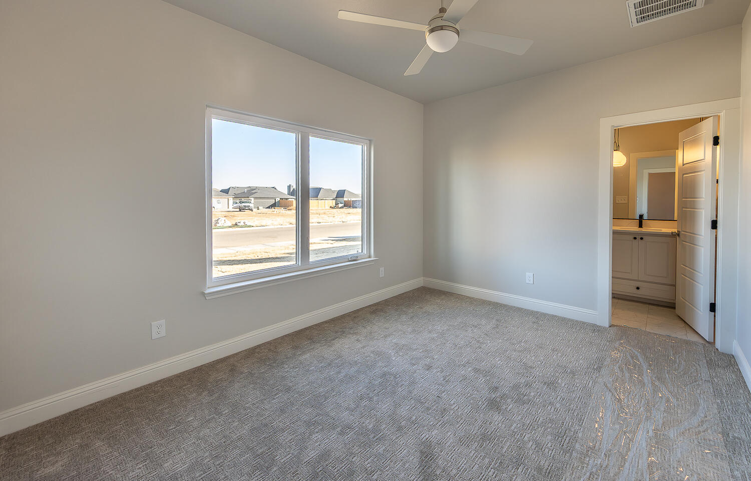 3607 143rd Street Lubbock, TX 79423 - Photo 27 of 35 an empty room with a window and a bathroom
