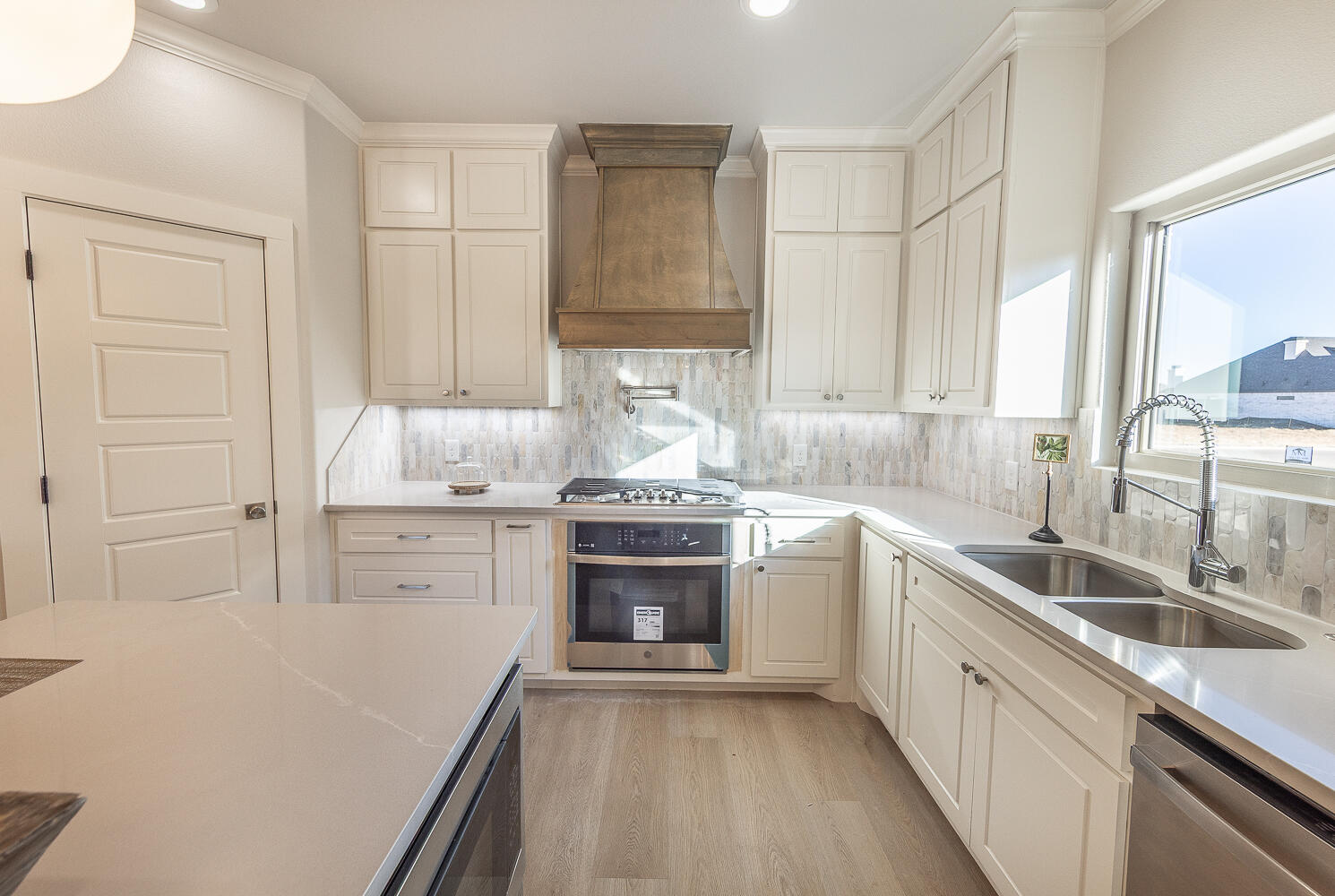 3607 143rd Street Lubbock, TX 79423 - Photo 3 of 35 a kitchen with a sink stove top oven and cabinets