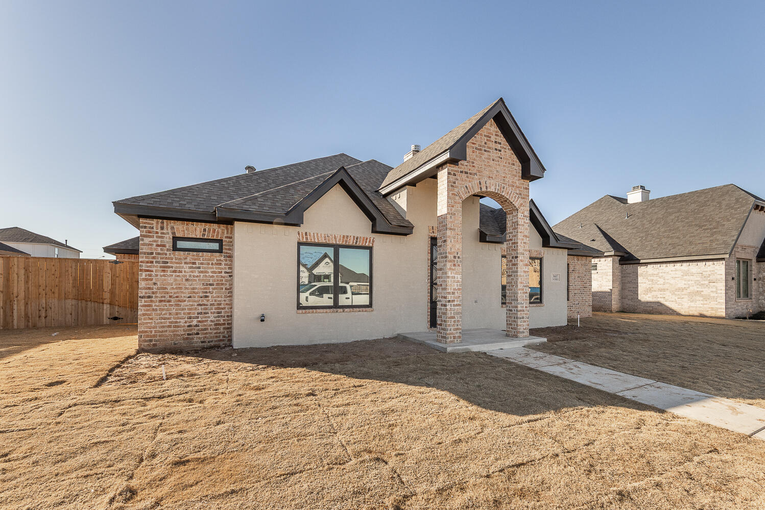3607 143rd Street Lubbock, TX 79423 - Photo 34 of 35 a front view of a house with a yard and garage