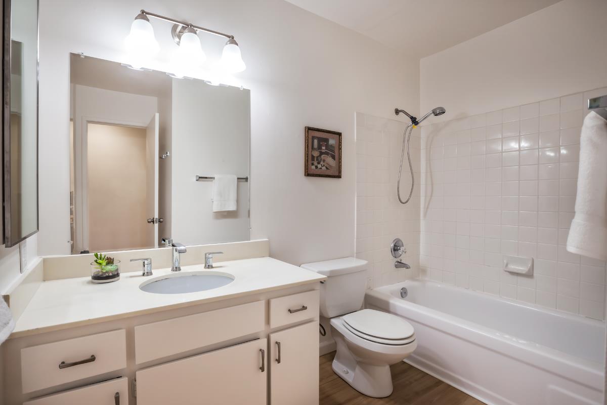 57 Pearce Mitchell Place Stanford, CA 94305 - Photo 13 of 13 a bathroom with a sink a toilet a mirror a bathtub and shower