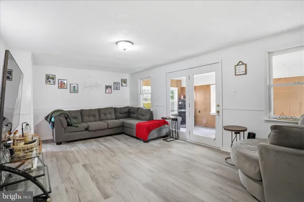 a living room with furniture window and wooden floor