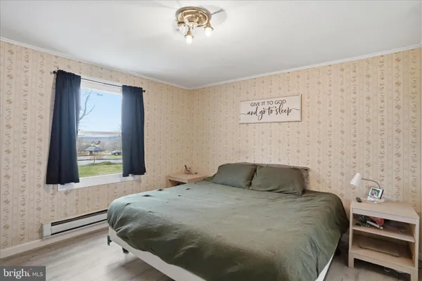a bedroom with a bed and a window