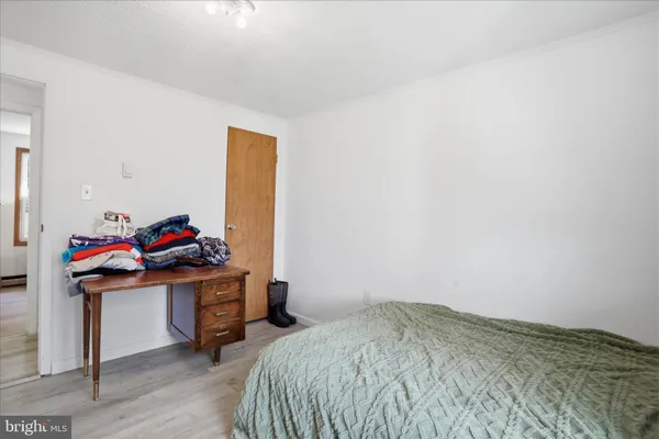 a bedroom with a bed and a dresser