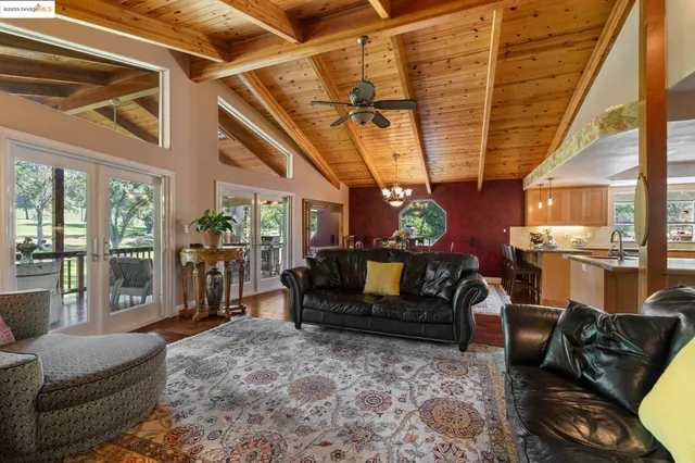 a kitchen with stainless steel appliances granite countertop a sink a stove top oven a counter space and cabinets