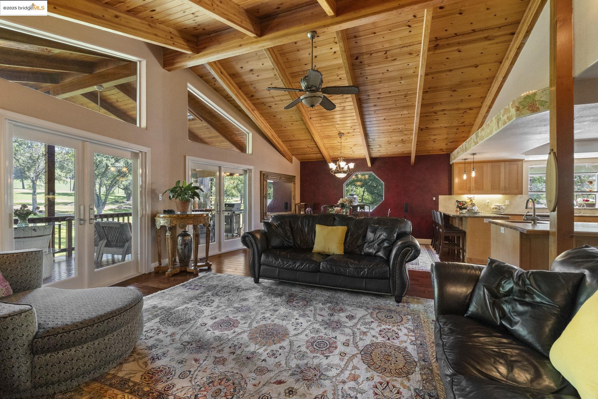 19400 Reid Circle Groveland, CA 95321 - Photo 26 of 60 a living room with furniture a flat screen tv and a floor to ceiling window