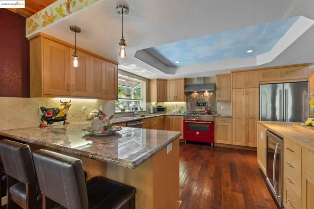 a kitchen with stainless steel appliances wooden cabinets and a stove