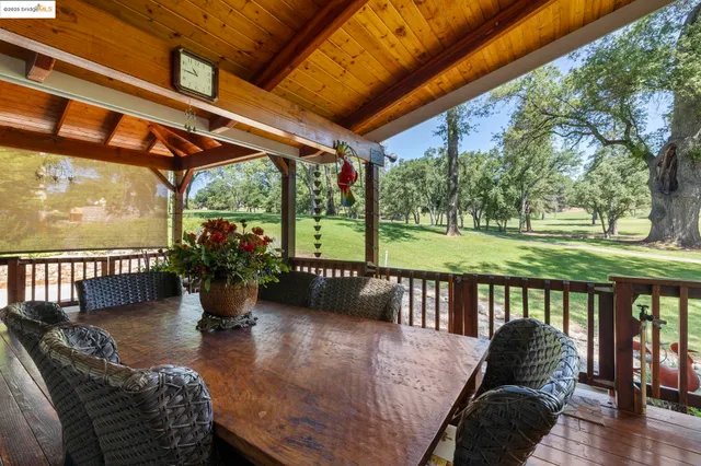 a living room with patio furniture and a floor to ceiling window