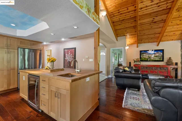 a living room with furniture and painting on the wall