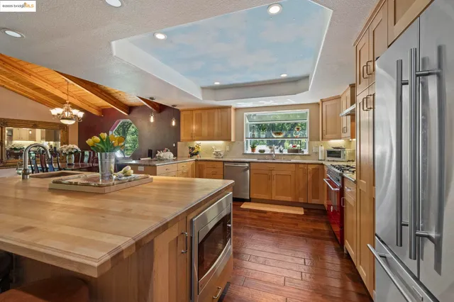 a spacious bedroom with a bed and wooden floor