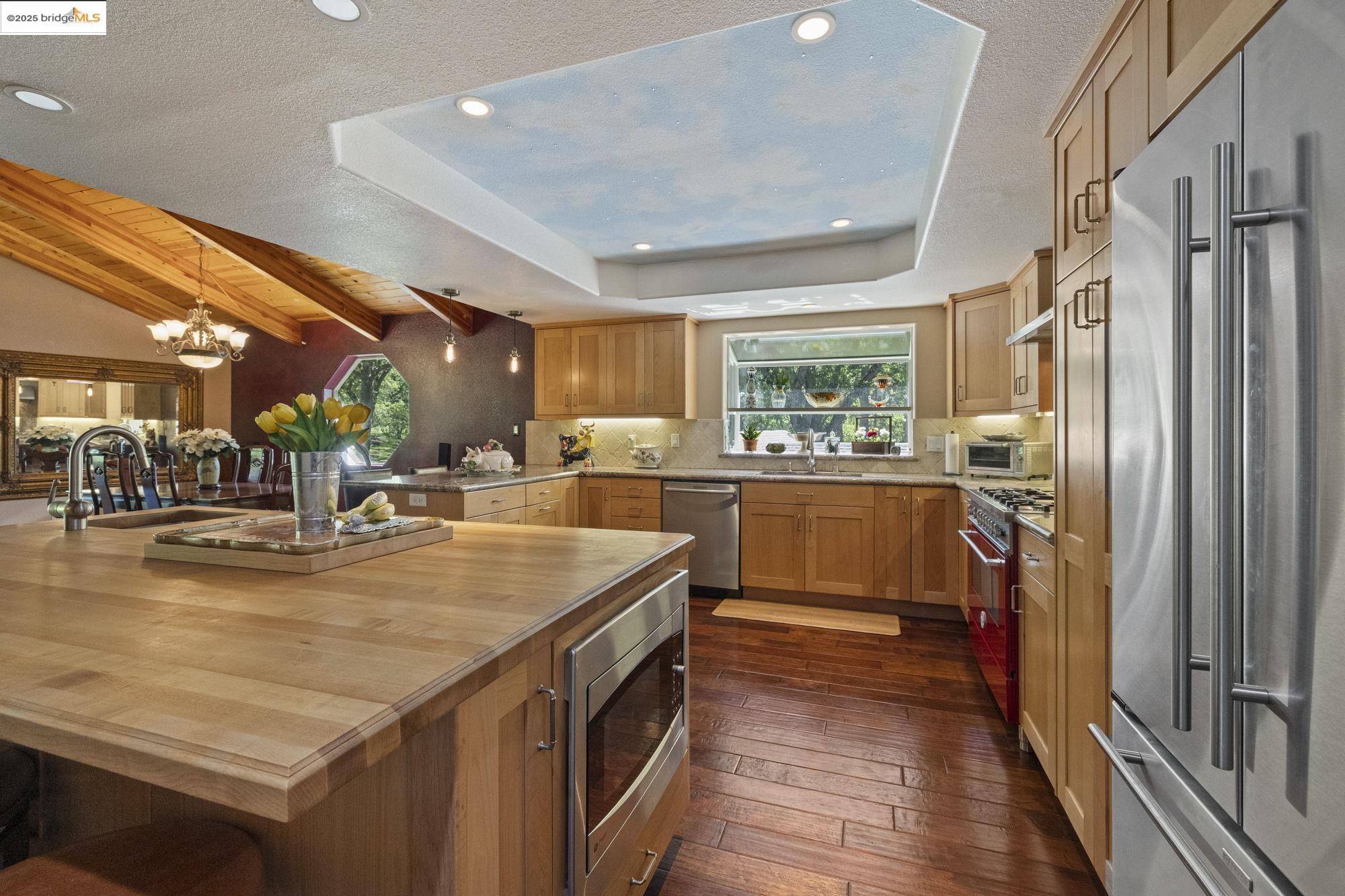 19400 Reid Circle Groveland, CA 95321 - Photo 33 of 60 a view of a kitchen with kitchen island a large counter top space a sink stainless steel appliances and cabinets