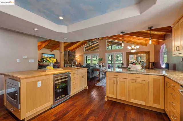 a bathroom with a granite countertop sink and a large mirror