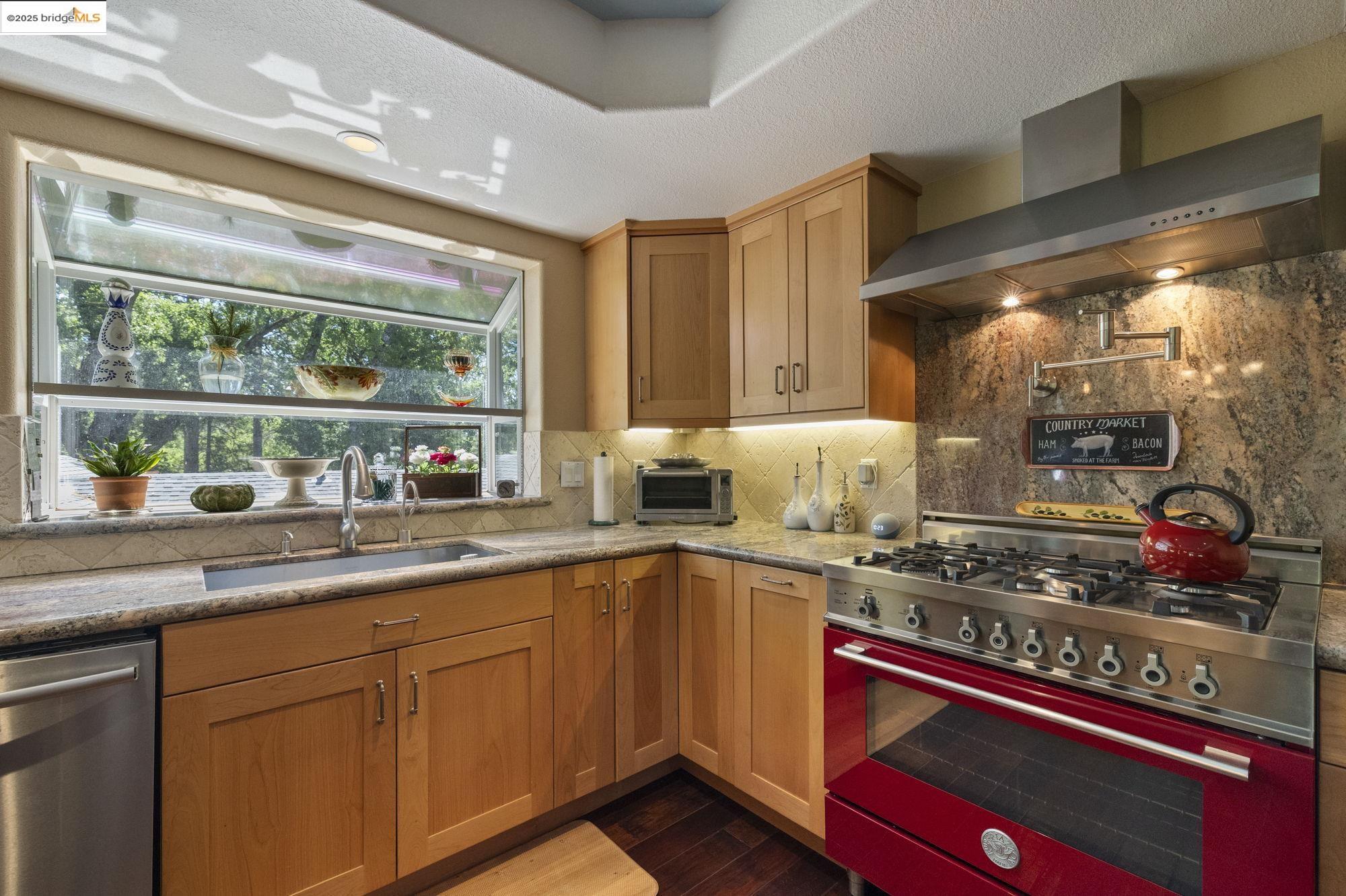 19400 Reid Circle Groveland, CA 95321 - Photo 35 of 60 a kitchen with stainless steel appliances wooden cabinets and a stove