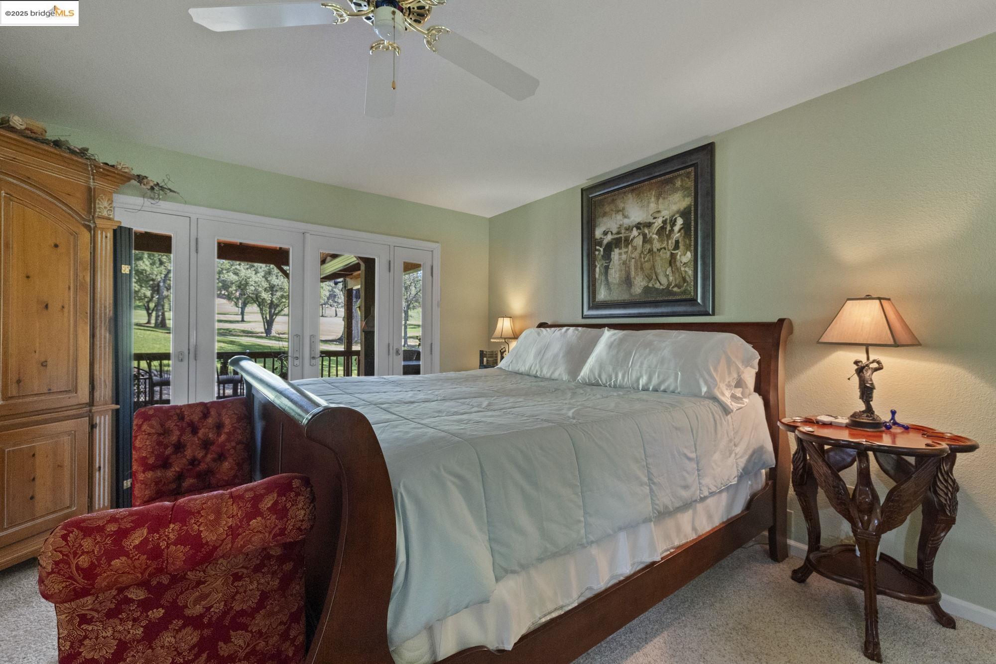 19400 Reid Circle Groveland, CA 95321 - Photo 36 of 60 a bedroom with a bed and a chandelier