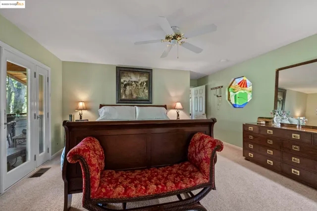 a bedroom with a bed and a chair