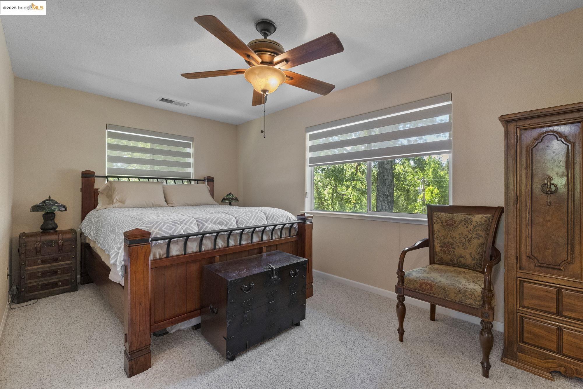 19400 Reid Circle Groveland, CA 95321 - Photo 42 of 60 a bedroom with a bed and a chair