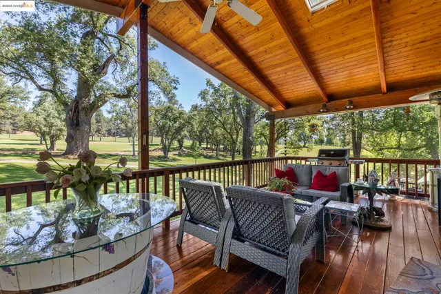 a view of a patio with couches chairs and a wooden floor