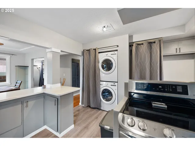 a kitchen with a refrigerator and a stove top oven