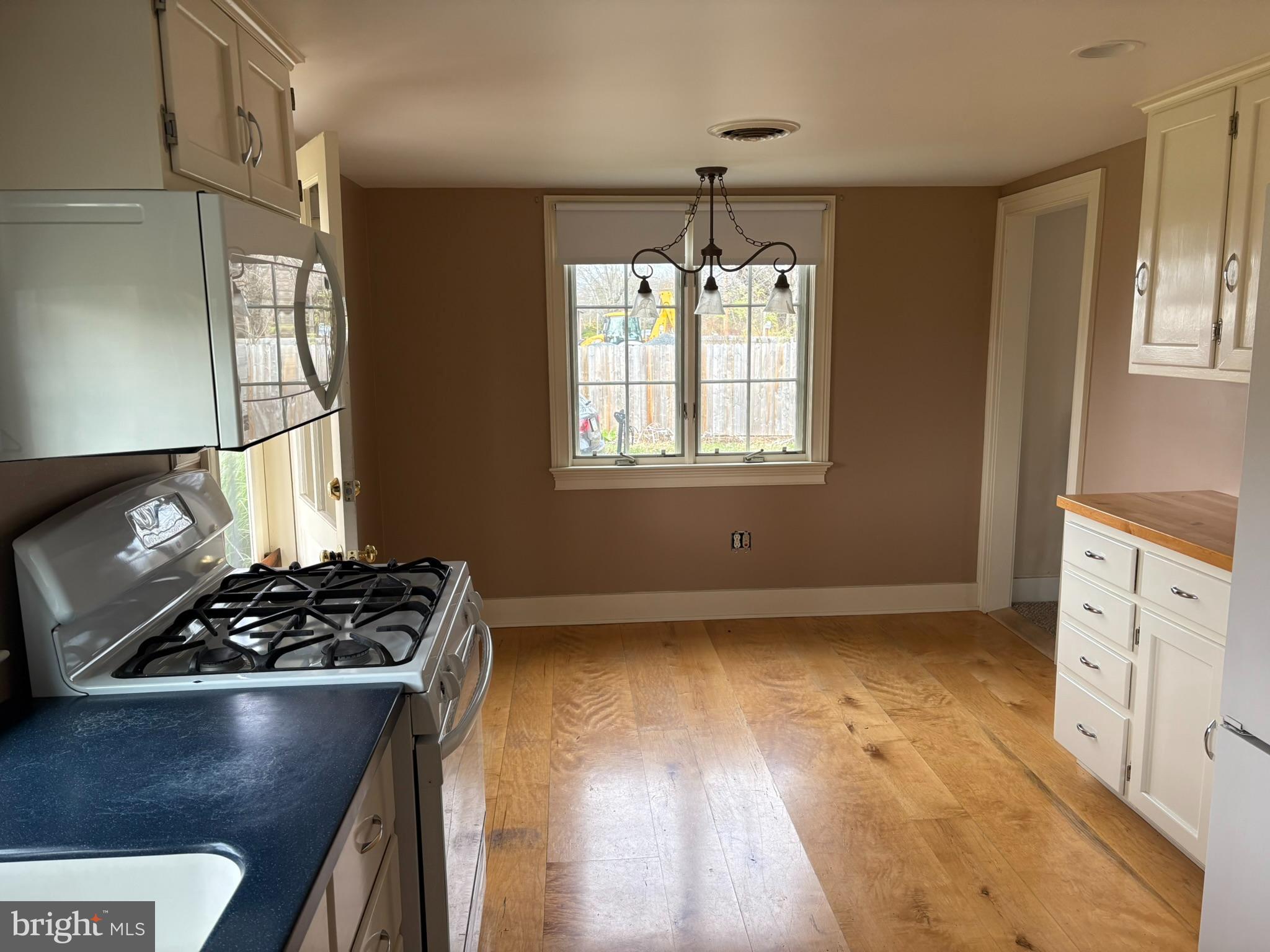 3842 Old Easton Road Doylestown, PA 18902 - Photo 7 of 13 a kitchen with granite countertop a stove and a wooden floor